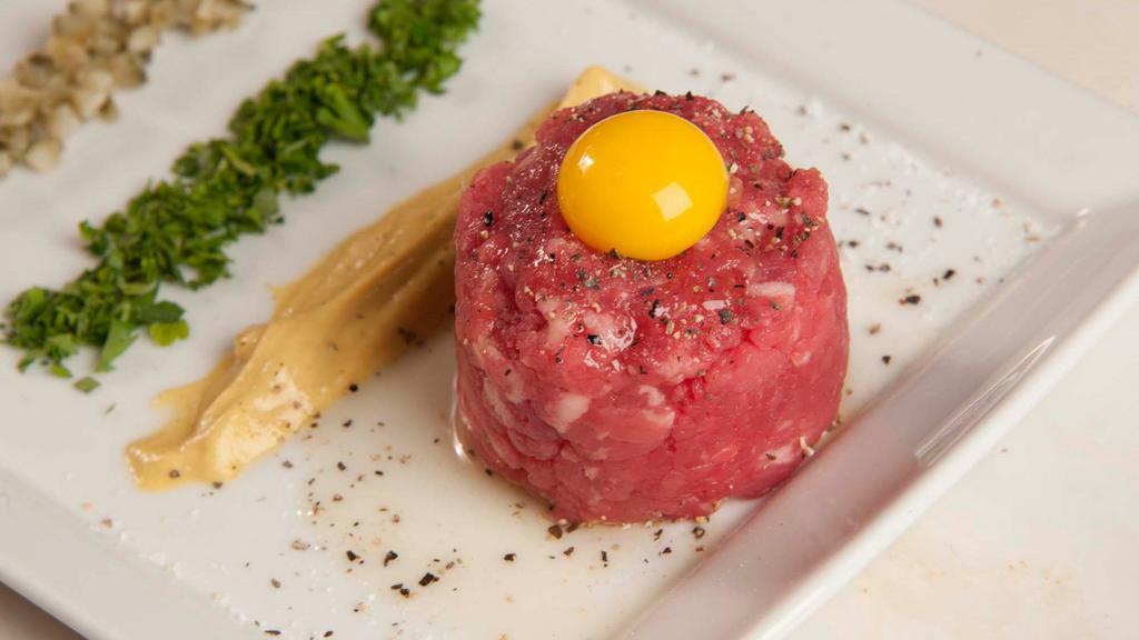 Steak Tartare · Parsley, capers, cornichons, dijon, red onion, lemon zest and quail egg.