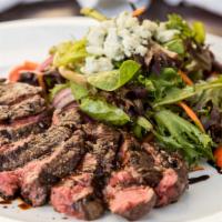 Susan's Steak Salad · Mixed baby greens, onions, cherry tomatoes, bleu cheese, daily butcher's cut dry-aged grille...