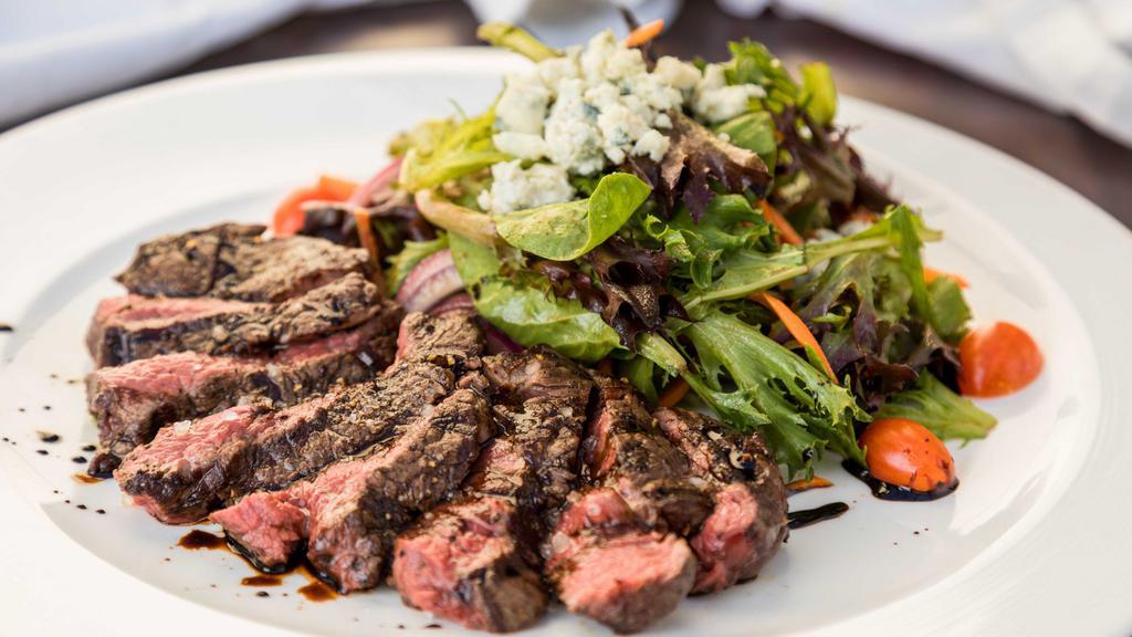 Susan's Steak Salad · Mixed baby greens, onions, cherry tomatoes, bleu cheese, daily butcher's cut dry-aged grilled steak, balsamic vinaigrette