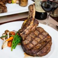 Cowboy · 18 oz dry aged bone-in ribeye, roasted cipollini and Demi glace. Served with twice baked pot...