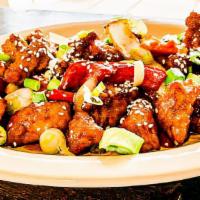 Orange Chicken · Crispy fried chicken in tangy sauce with yellow onion, bell peppers and carrot, topped with ...