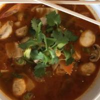 Tom Yum Noodle Soup · Flat rice noodle, ground pork, meatball, bean sprout, green onions topped w. ground peanut.