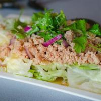 Larb Pork · Ground pork toss with grounded roasted rice, chili powder. mint in chili lime dressing