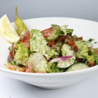 Fattoush Salad · Vegetarian. Romaine hearts, cucumber, tomato, onion, bell peppers, dried mint, sumac, pita c...