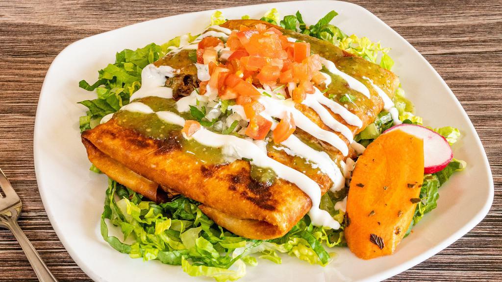 Chimichanga · Crispy fried burrito wrapped with choice of meat, Mexican rice, pinto beans and melted cheese. Topped with salsa, onion, cilantro, tomato, lettuce, sour cream.