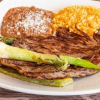 Carne Asada · Grilled carne asada topped with grilled onions and serrano peppers.