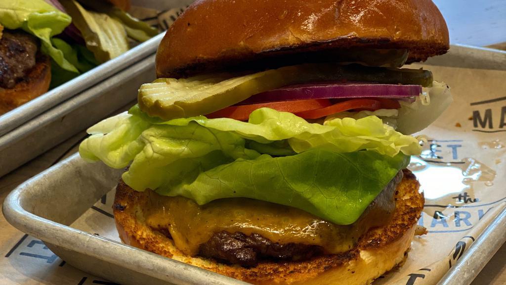 100% Angus Burger · Lettuce, tomato, red onion, pickles and garlic aioli on a potato bun.