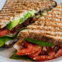 Turkey Club Sandwich · Sliced turkey, mayo, bacon, tomato, butter leaf lettuce and avocado on sliced whole grain wh...