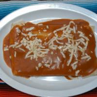 Wet Quesadilla · Flour tortilla with cheese, meat and salsa covered with red sauce and cheese.