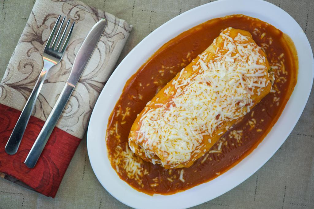 Wet Burrito · Rice, whole pinto beans, choice of meat, sour cream, guacamole , salsa, topped with sauce and cheese