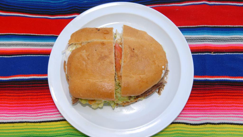 Torta Mexicana · Mexican bread, re-fried beans, cheese, guacamole, sour cream, lettuce, tomato, jalapeño peppers and meat.
