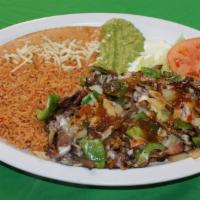 Alambres · Grilled steak sautted with bacon, bell peppers, onions and tomatillo sauce topped with chees...