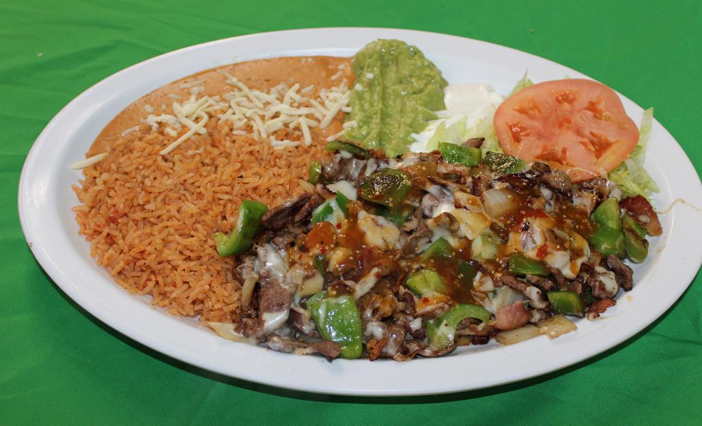 Alambres · Grilled steak sautted with bacon, bell peppers, onions and tomatillo sauce topped with cheese. Served with rice, re-fried beans, lettuce, guacamole, sour cream and corn or flour tortillas.