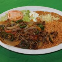 Bistec Ranchero · Grilled steal sauteed with jalapeno peppers, onions, tomato and tomatillo sauce. Served with...