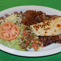 Parrillada Mexicana · Beef, bacon, chorizo, small quesadilla served with rice, whole pinto beans, lettuce, pico de...