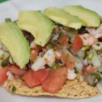 Tostada De Ceviche · Shrimp or fish:  tortilla shell with lime, crab, shrimp, onions, tomatoes, cilantro and avoc...