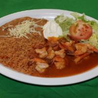 Camarones Al Mojo De Ajo · Shrimp with special garlic sauce, served with rice, re-fried beans, lettuce, sour cream, gua...