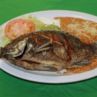 Mojarra Frita · A tilapia fish served with rice, re-fried beans, lettuce, guacamole, sour cream, salsa and c...