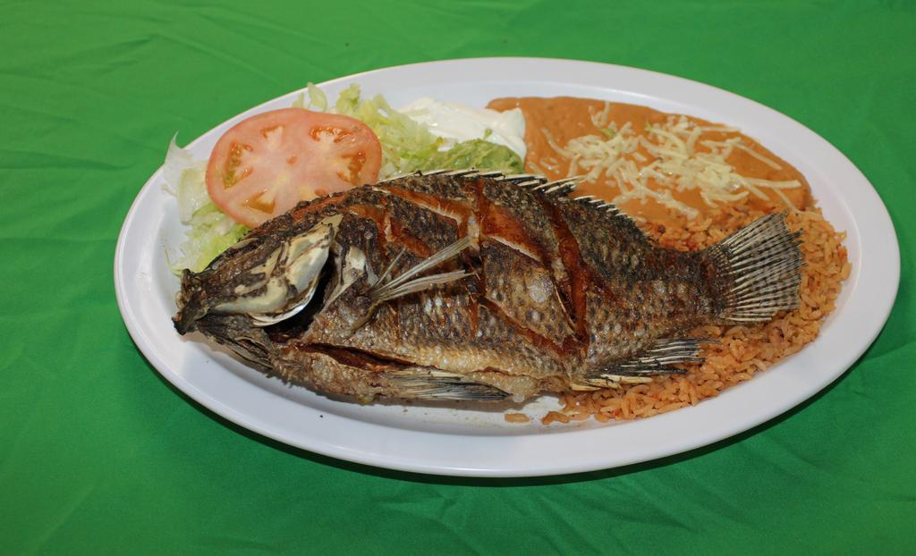 Mojarra Frita · A tilapia fish served with rice, re-fried beans, lettuce, guacamole, sour cream, salsa and corn or flour tortillas.