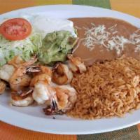 Camarones a la Plancha · Grilled shrimp with refried beans, rice, lettuce, guacamole, sour cream, cheese and tortillas.
