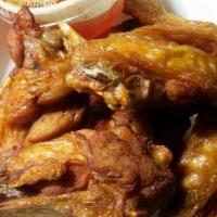 Fried Chicken Wings · Fried chicken wings marinated in pepper and garlic. Served with spicy sweet and sour sauce.