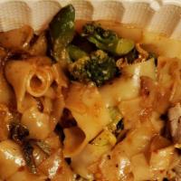 Pad Kee Mao · Hot. Pan-fried wide rice noodles sautéed with broccoli, fresh chili, garlic, egg and Thai ba...