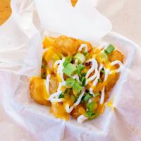 Tot-Chos · Crispy tater-tots with melted cheese, bacon, sour cream, and green onion.