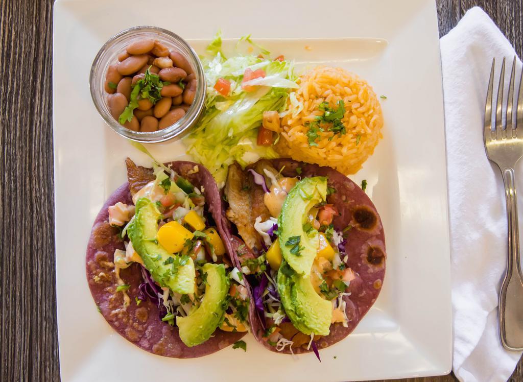 Fish Taco · Tilapia fish seasoned, garnished with mango pico de gallo, avocado, green and red cabbage and topped with chipotle mayonnaise sauce