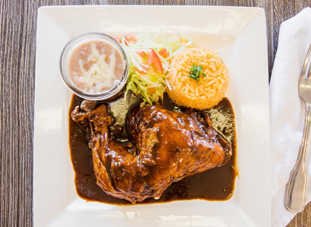 Chicken Mole · A blend of different chilies and nuts in a chocolate sauce over a chicken portion. Serve with rice, beans and your choice of tortillas.
