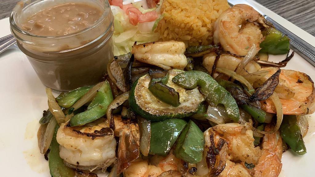 Fajitas · chicken,beef or prawns grilled  with onions, bell peppers and tomatoe Served with rice and beans and your choice of tortilla