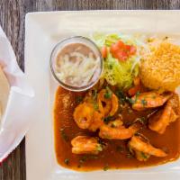Camarones a La Diabla · Shrimp sautéed with chili the arbol sauce, serve with rice and beans and your choice of tort...