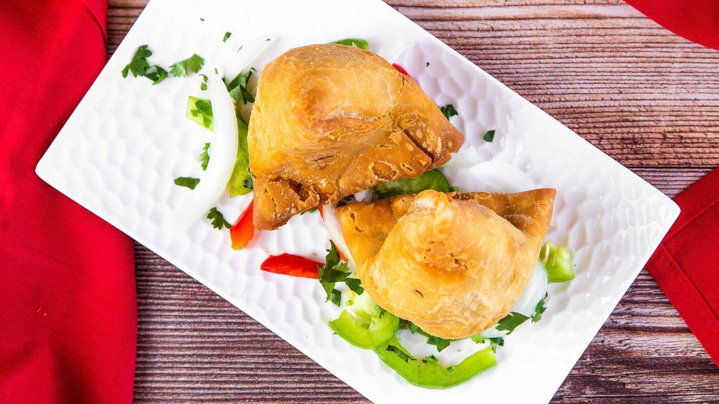 Samosa · Two pieces. Veggie turnover, stuffed with potatoes, green peas, herbs and spices, served with chutney.