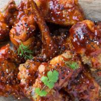 The Cajun Wings · Cajun flavored sauce smothered on oven-baked chicken wings batch! Served with Ranch.