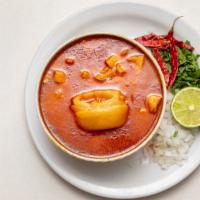 Menudo · made with beef stomach (tripe) in broth with a red chili pepper base, lime, onions, and oreg...
