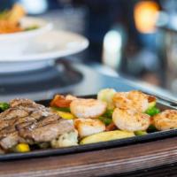 Surf & Turf New York Steak · 8 ounces NY steak and grilled prawns with grilled seasonal vegetables.
