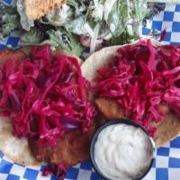 Fish Tacos · Two crispy breaded tilapia with tartar sauce and cabbage.
