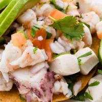 Nayarita Ceviche Tostada · Fresh shrimp, octopus, abalone,  lime juice, onion, cucumber,  jalapeño, tomato and cilantro
