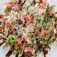 Sloppy Style Housemade Gyoza · Deep fried and topped with green onions, sauces, pickled ginger, and bonito flakes (on the p...