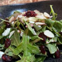 Insalata Delizie · Arugula salad, feta cheese, almonds, dried cranberries in light raspberry dressing