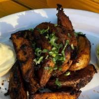 Chili-Blackened Potato Wedges · Baked yukon gold potatoes served with citrus aioli and cilantro-jalapeno sauce. Tossed in ch...