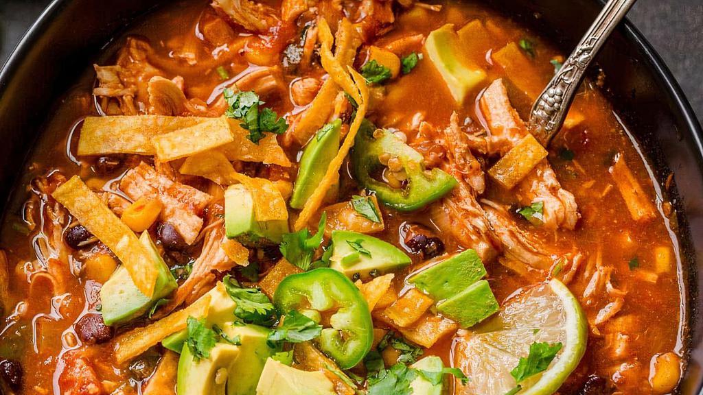 Chicken Tortilla Soup · Hot and hearty chunks of tender chicken breast and fresh avocados are steamed up with tortilla strips and shredded cheese in a rich chicken broth.