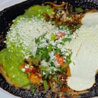 Wet Burrito Mole · insede rice,beans,cilantro,meat,onions,sauce,
 top mole, mealted cheese,guacamole,sour cream...