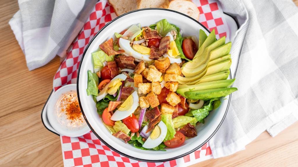 The Wedgie Salad · Romaine, hard boiled eggs, bacon, avocado, cherry tomatoes, red onions, sunflower seeds, garlic croutons,  ranch dressing.