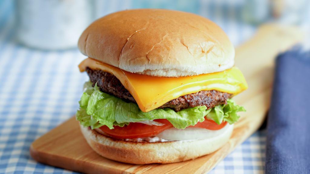 Cheeseburger · A 1/3 lb. all beef patty served on a toasted bun with tomatoes, lettuce, onions and dressing. Comes with two thick slices of melted cheese.