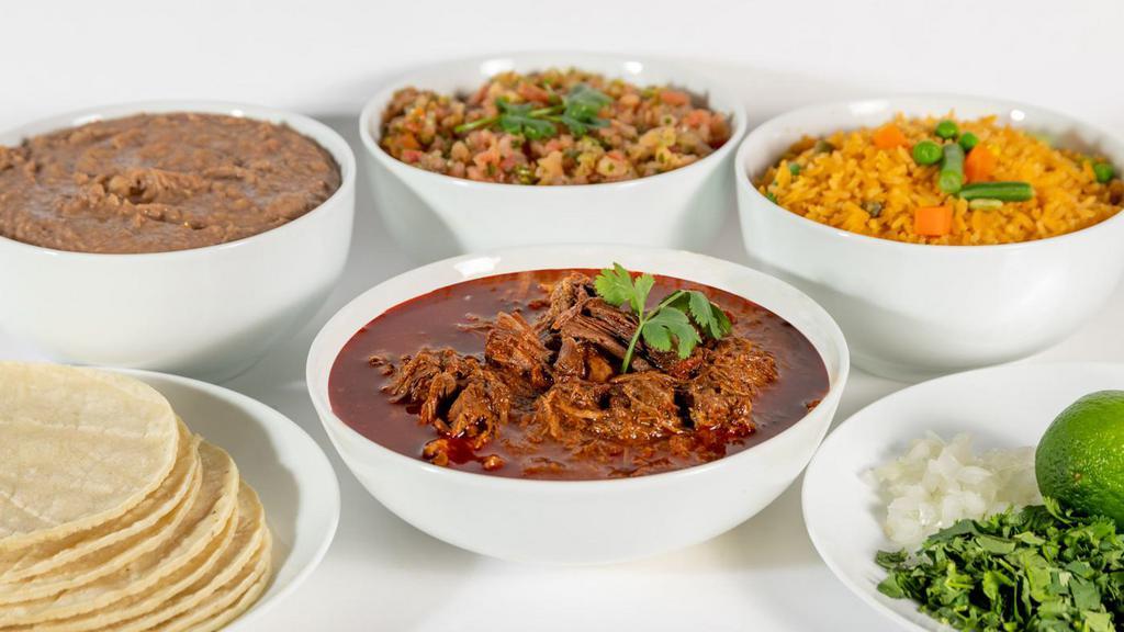 Birria Family Pack · Slow cooked beef pot roast is simmered in a blend of chilies and spices served with arroz, frijoles, salsa and tortillas.