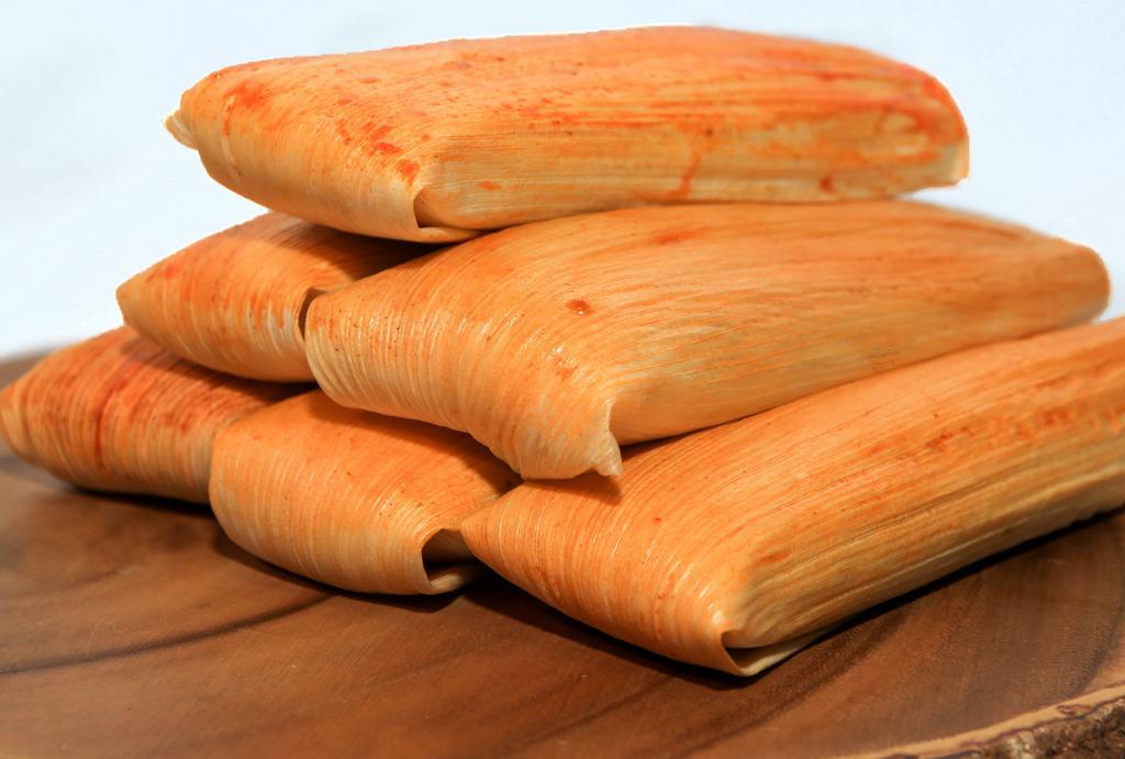 Tamales (ea) · Cooked in corn husks, prepared with corn meal dough filled with a savory filling of your choice.