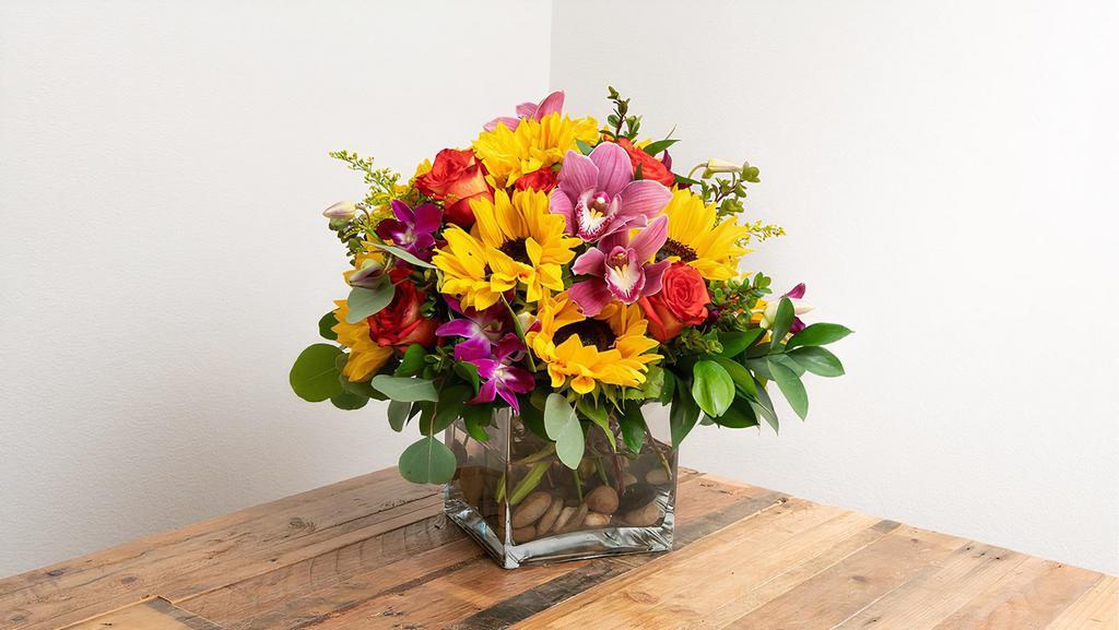 Celebration Arrangement In A Vase · This vibrant arrangement adds a celebratory feel to all events and festivities!

-- Picture represents the Large version of this arrangement --

Seasonal options will vary throughout the year and depending on location. Our florist will provide the best available flowers for your order!