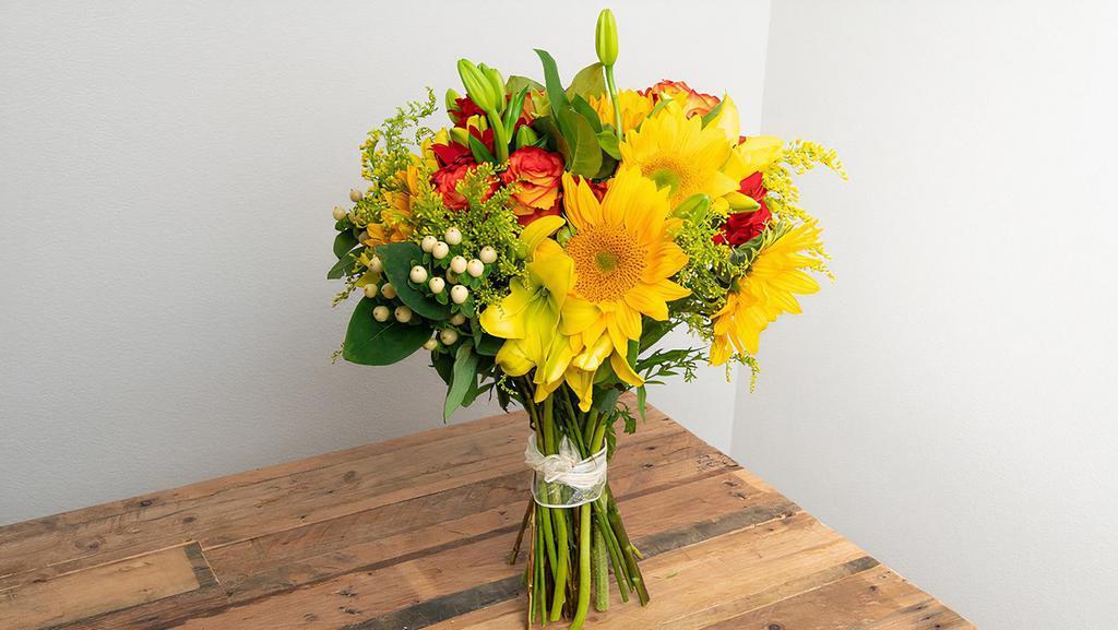 Yellow, Orange, Red Wrapped Bouquet · Seasonal options may vary throughout the year and depending on location. Our florist will provide the best available flowers for your order!