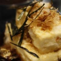 Agedashi Tofu · Fried tofu cubes served in a tentsuyu broth topped with dried seaweed and bonito fish flakes.