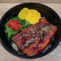 Unagi Donburi 鰻丼 · Unagi (Eel) over steamed rice. Sesame. Yellow and Red Pickled Radish. Unagi Sauce.